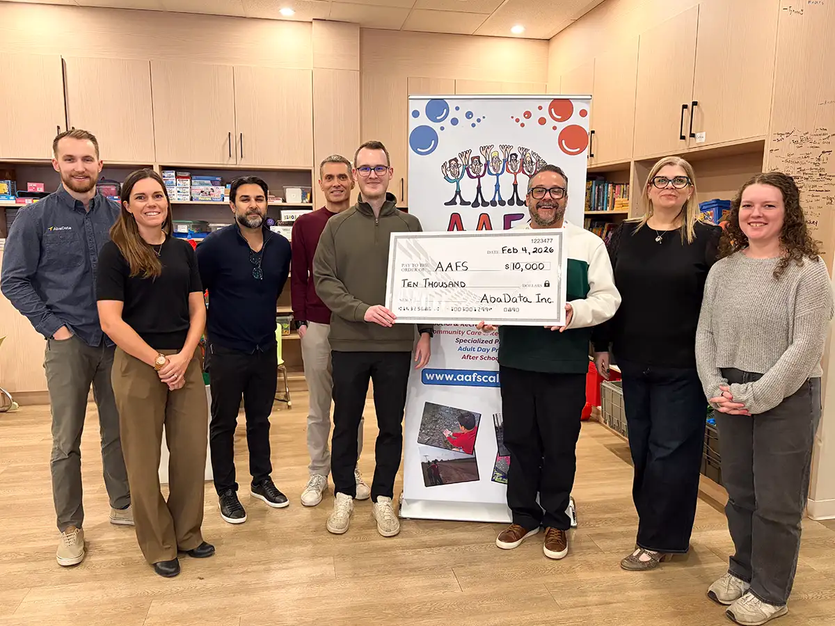 AbaData Charity Cheque Delivery Autism Asperger's Friendship Society with AbaData executives handing over a $10,000 cheque to Autism Asperger's Friendship Society members
