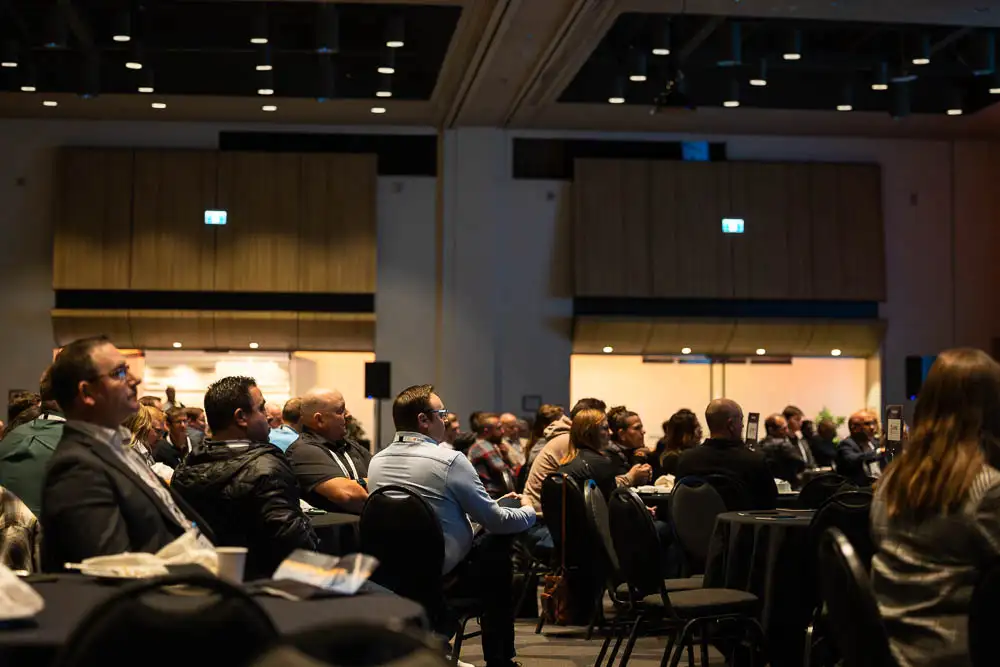 AbaData User Conference 2025 Images (13 of 20) showing a room full of conference attendees intently listening to the keynote address