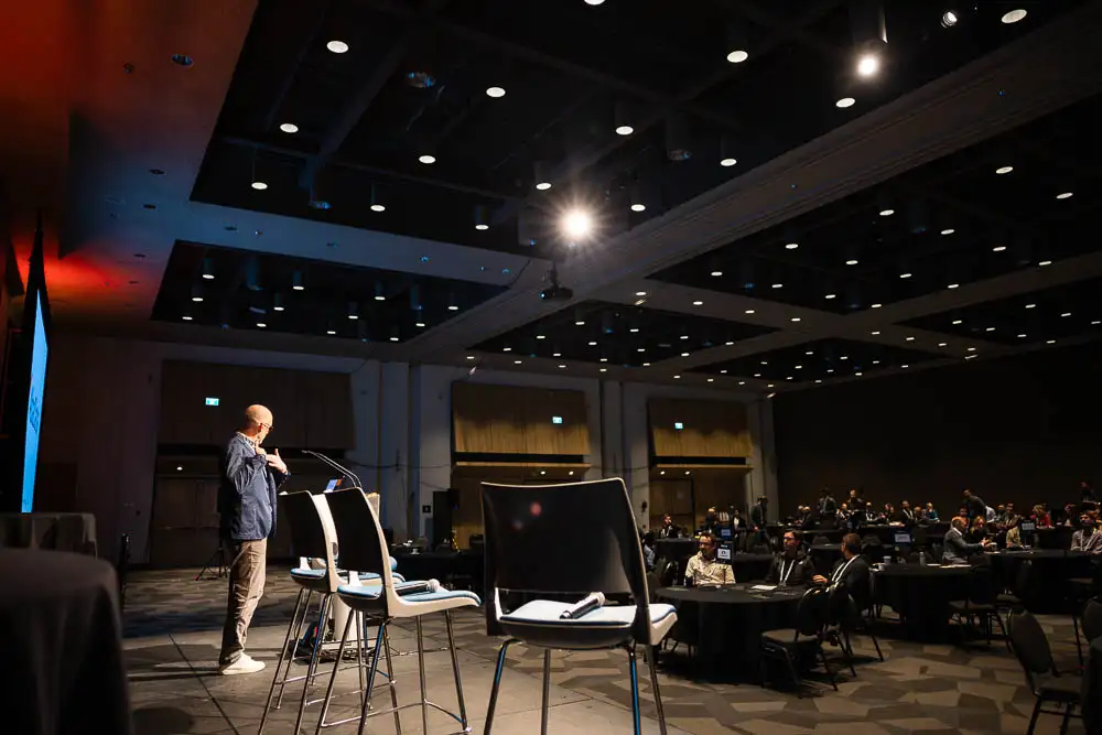 AbaData User Conference 2025 Images (17 of 20) image from the stage looking out to a full crowd with bright lights shining