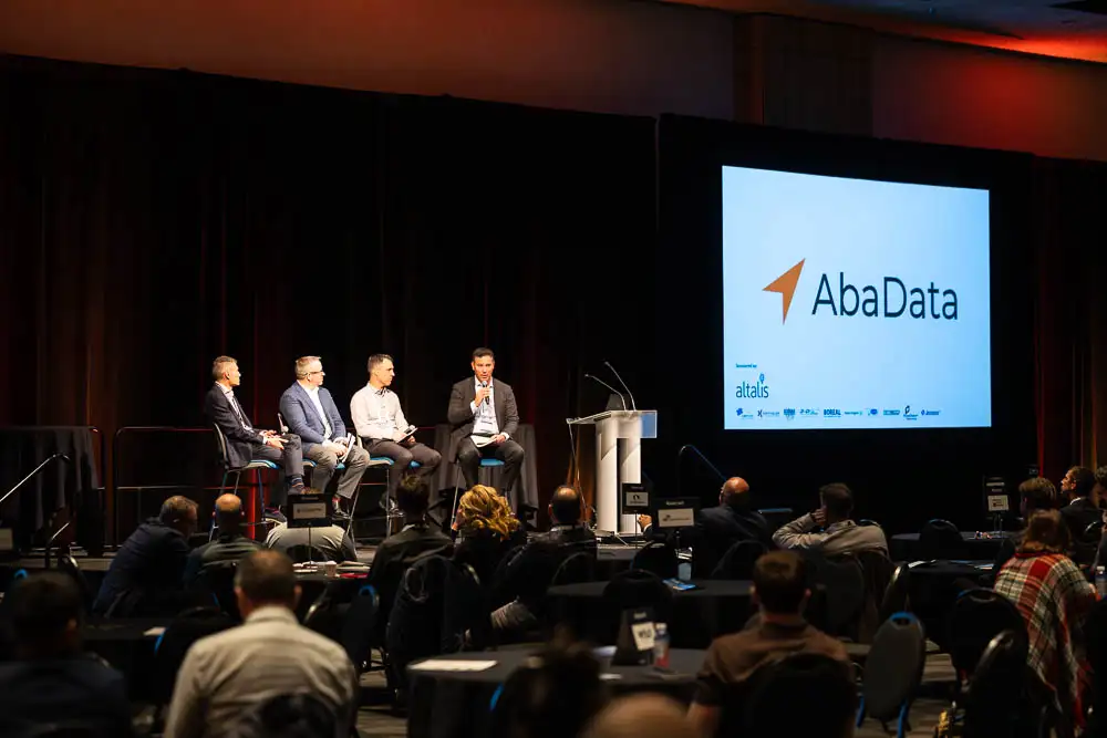 AbaData User Conference 2025 Images (20 of 20) with AbaData logo on screen, and expert industry panelists on stage